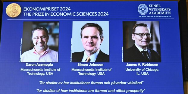 Projektion mit den Portraits der 3 Nobelpreisträger Wirtschaftswissenschaften Projektion mit den Portraits der 3 Nobelpreisträger Wirtschaftswissenschaften